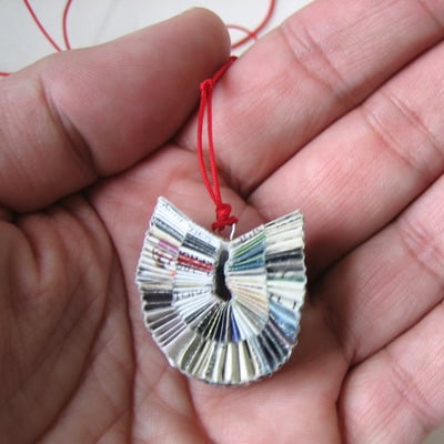 Junk Mail Necklace Hanging On Red Cord
