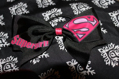 "SUPERGIRL" CHEER BOW; 2 in Black Grosgrain Ribbon with a Hot Pink center