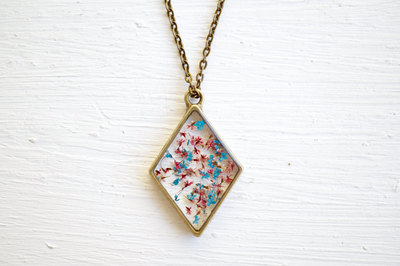 Real Pressed Flower and Resin Moon Necklace in Blues, Pinks, and Whites.