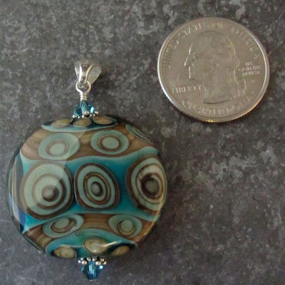 Aqua and fossil flameworked pendant