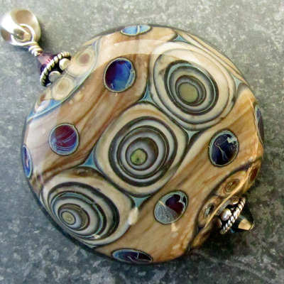 Purple blue on fossil flameworked pendant