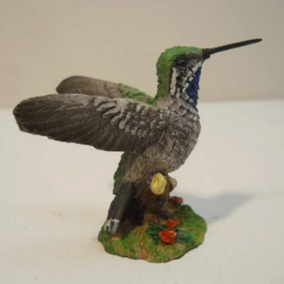 Open wing hummingbird with colorful floral decorative figurine statue