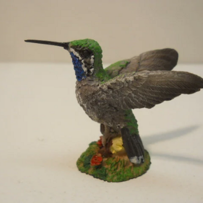 Open wing hummingbird with colorful floral decorative figurine statue