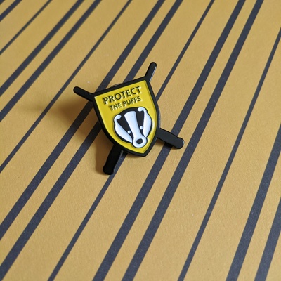 Limited edition "protect the puffs" enamel campaign pin to benefit the badger trust