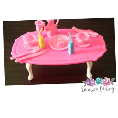 Table with 10+pcs. of utensils and dinnerware for fashion dolls