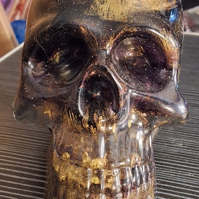 Purple and metallic gold resin skull
