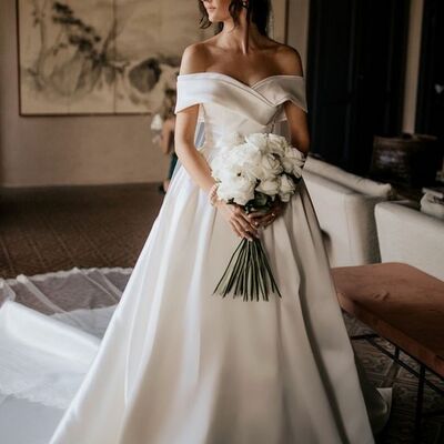 Off-the-shoulder white satin wedding dress