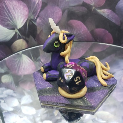 Purple and black unicorn dice guardian