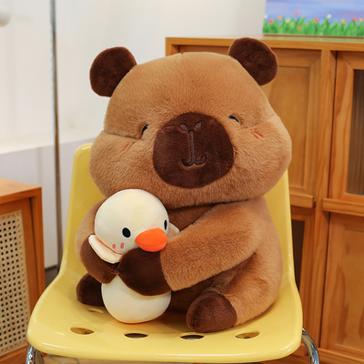 Cute capybara plush toy cuddling a duck doll
