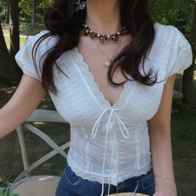 White lace v-neck top with ties on the chest