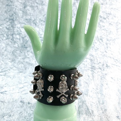 Skull leather wrist band with silver skulls and spikes