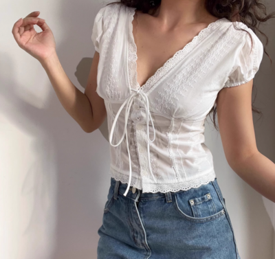 White lace V-neck top with ties on the chest