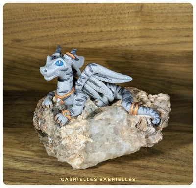 Clawdia the Tabby Dragon polymer clay sculpture on raw quartz crystal rock