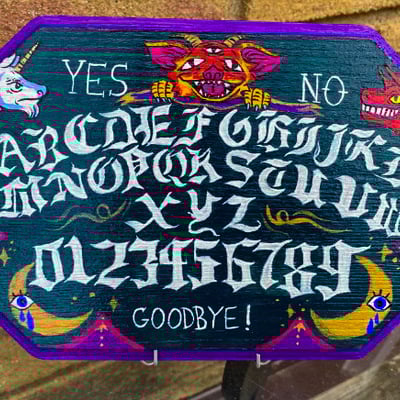 Fantastical hand-painted wooden spirit board