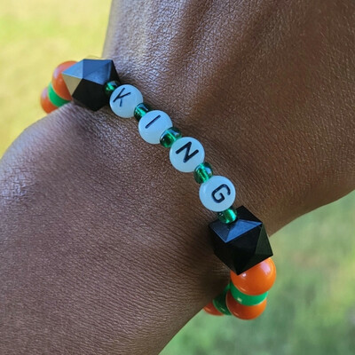 Famu king 👑🧡💚 glow in the dark alphabet bracelet🐍🐍🧡💚 ready-made🎨⏳️ by nubian collection artwear 👑