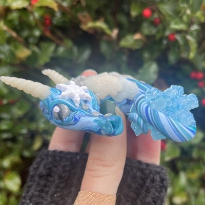 Frost the sleepy blue snowflake dragon