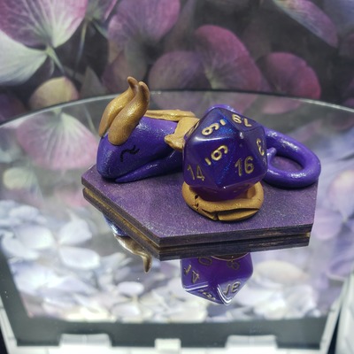 Sleepy purple and gold dragon dice guardian
