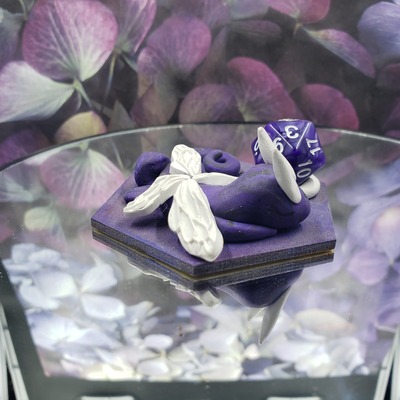 Sleepy purple and white dragon dice guardian