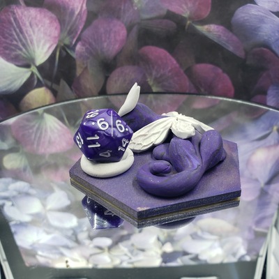 Sleepy purple and white dragon dice guardian