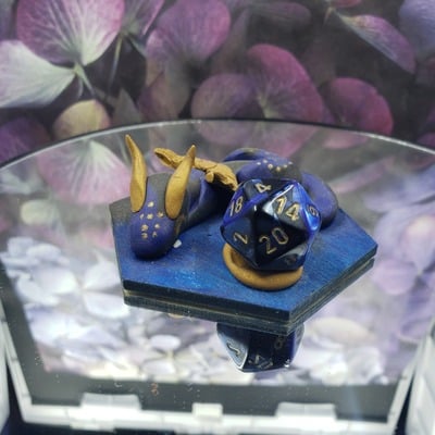 Sleepy blue and black dice guardian