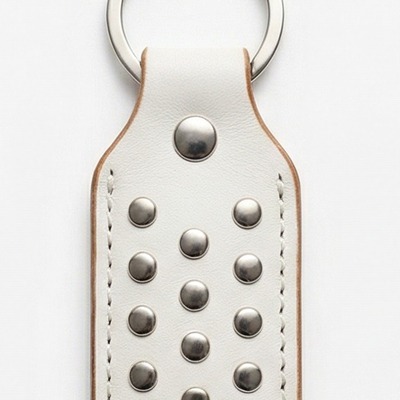 White and gray studded leather keychain