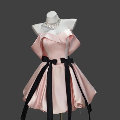 Blush off-shoulder mini dress with black bow accents