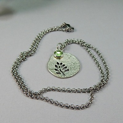 August birthstone leaf pendant necklace - handmade silver leaf cutout with peridot crystal charm