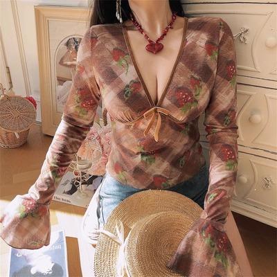 Deep v-neck blouse with bow detail and flared sleeves (a trendy and alluring style)