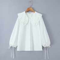 White loose-fitting long-sleeved shirt with lace trim and a large lapel, featuring a single row of buttons. - Thumbnail 2