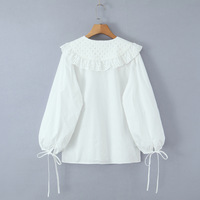White loose-fitting long-sleeved shirt with lace trim and a large lapel, featuring a single row of buttons. - Thumbnail 3