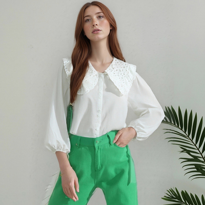 White loose-fitting long-sleeved shirt with lace trim and a large lapel, featuring a single row of buttons.