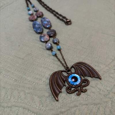 Blue winged eyeball necklace