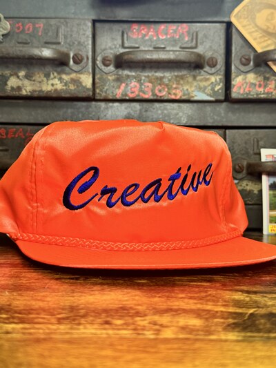 CREATIVE Orange w/ blue stitch hat 