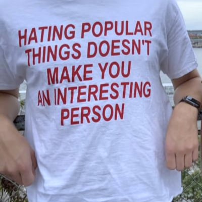 Free shipping-"hating popular things doesn't.." tee