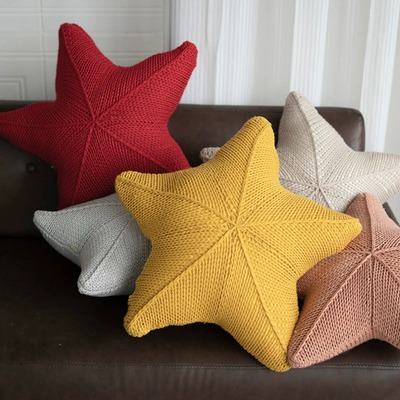 Starfish-shaped knitted cushions made with stuffing