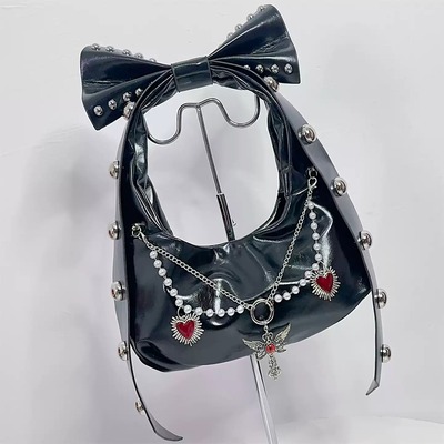 Y2k-style shoulder bag featuring a large studded bow