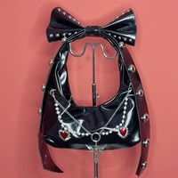 Y2K-style shoulder bag featuring a large studded bow - Thumbnail 1
