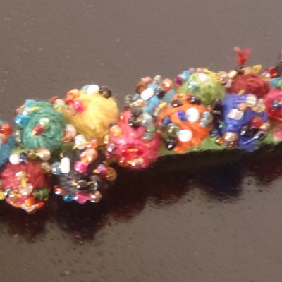 Green thread pom pom bracelet