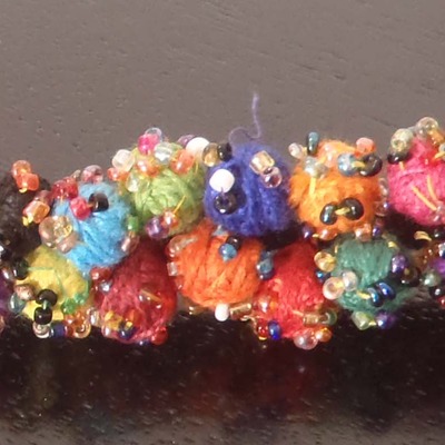 Black thread pom pom bracelet