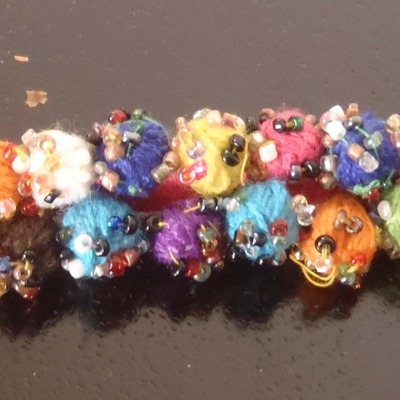 Pink thread work pom pom bracelet