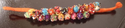 Orange thread pom pom bracelet