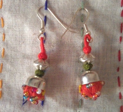 100 percent hand-made orange pom pom thread work earrings