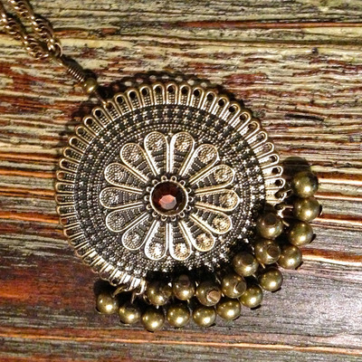 Long necklace with intricate pendant