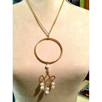 O ring Pendant with Pearls dangling from it