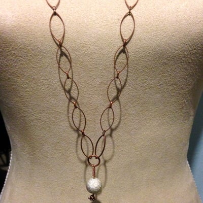 Long rose gold necklace with silver ball pendant