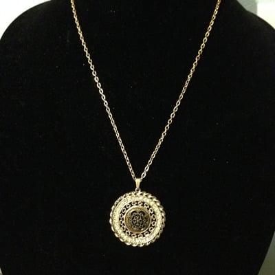 Ornate pendant on gold chain