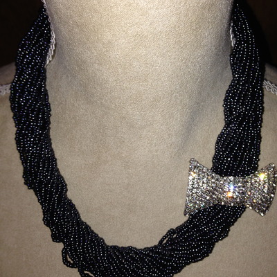 Black multi chain with flashy bow tie brooch