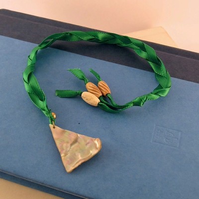 Green ribbon bookmark with mop triangle shell and carved bone