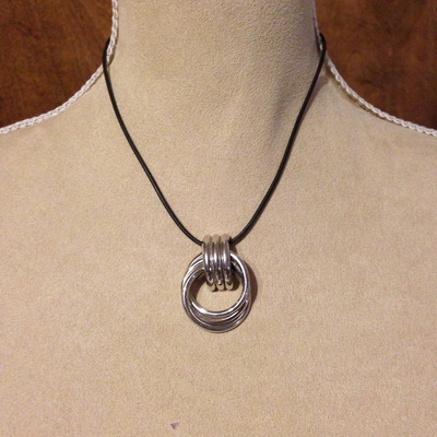 Silver pendant with black cord necklace
