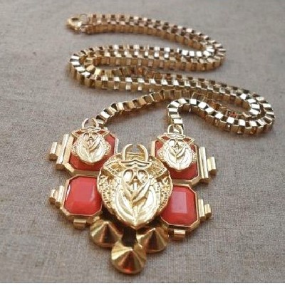 "bug me orange" pendant necklace